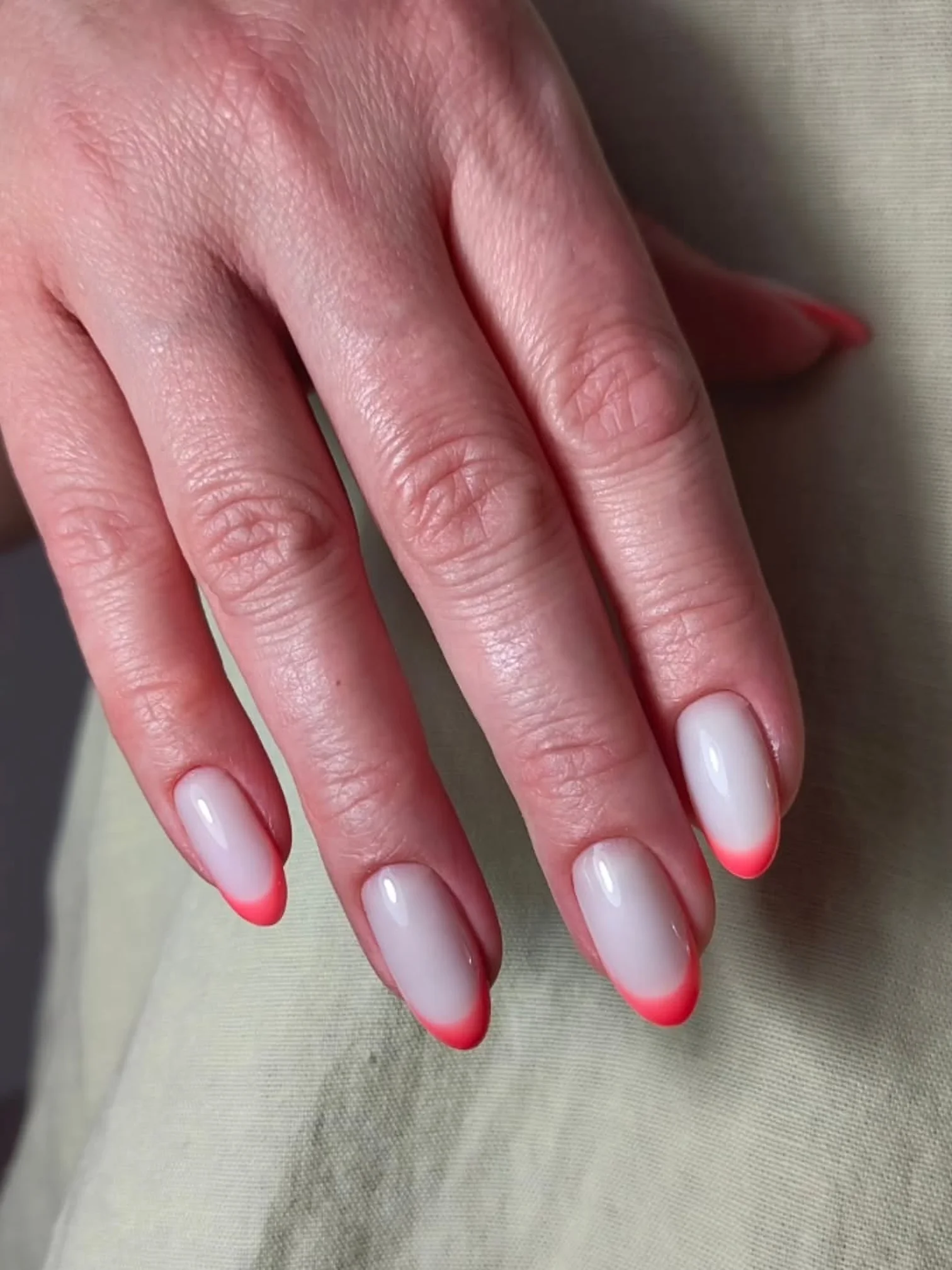 Almond nails with a thin neon orange tip