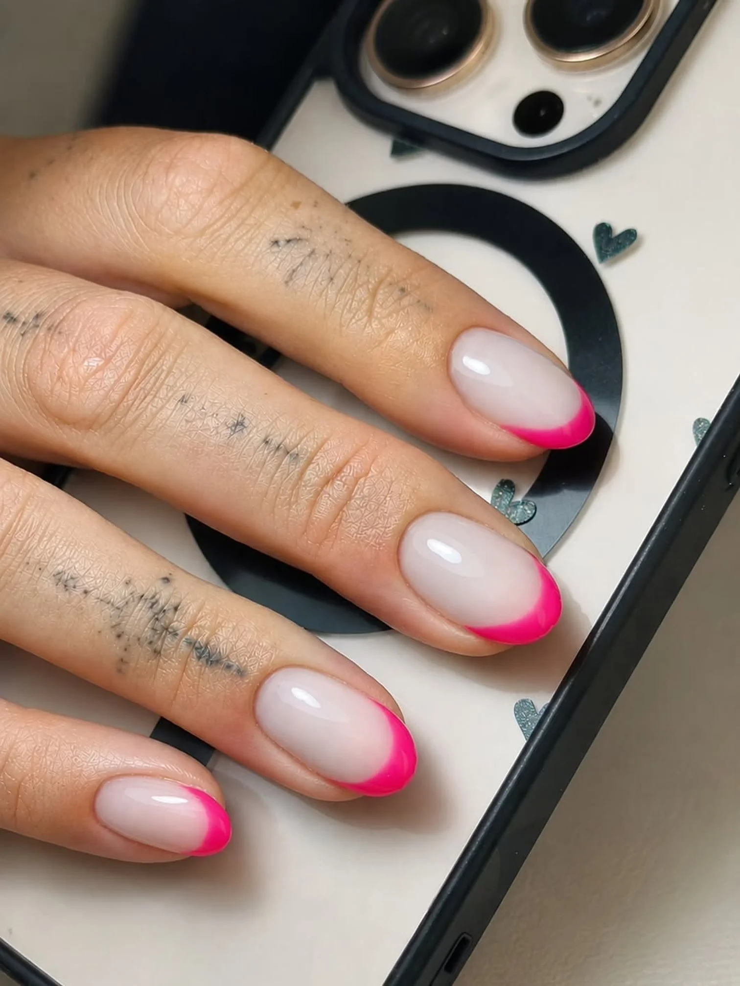 Almond nails with a neon pink French tip